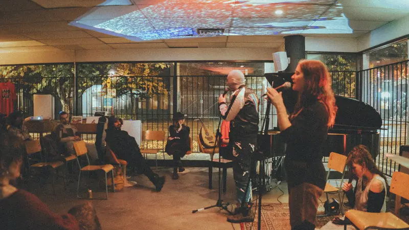 Captain Real Estate performing live to a seated audience in an intimate venue
